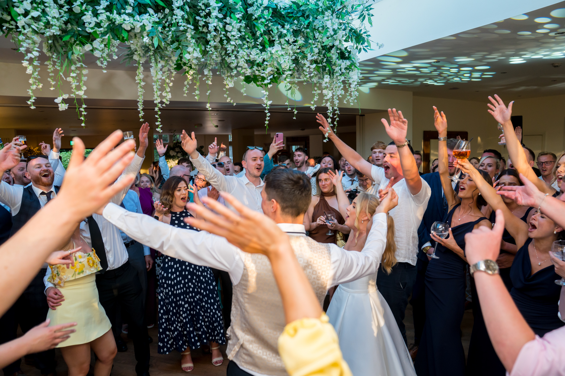 Group celebrating at a lively indoor party.