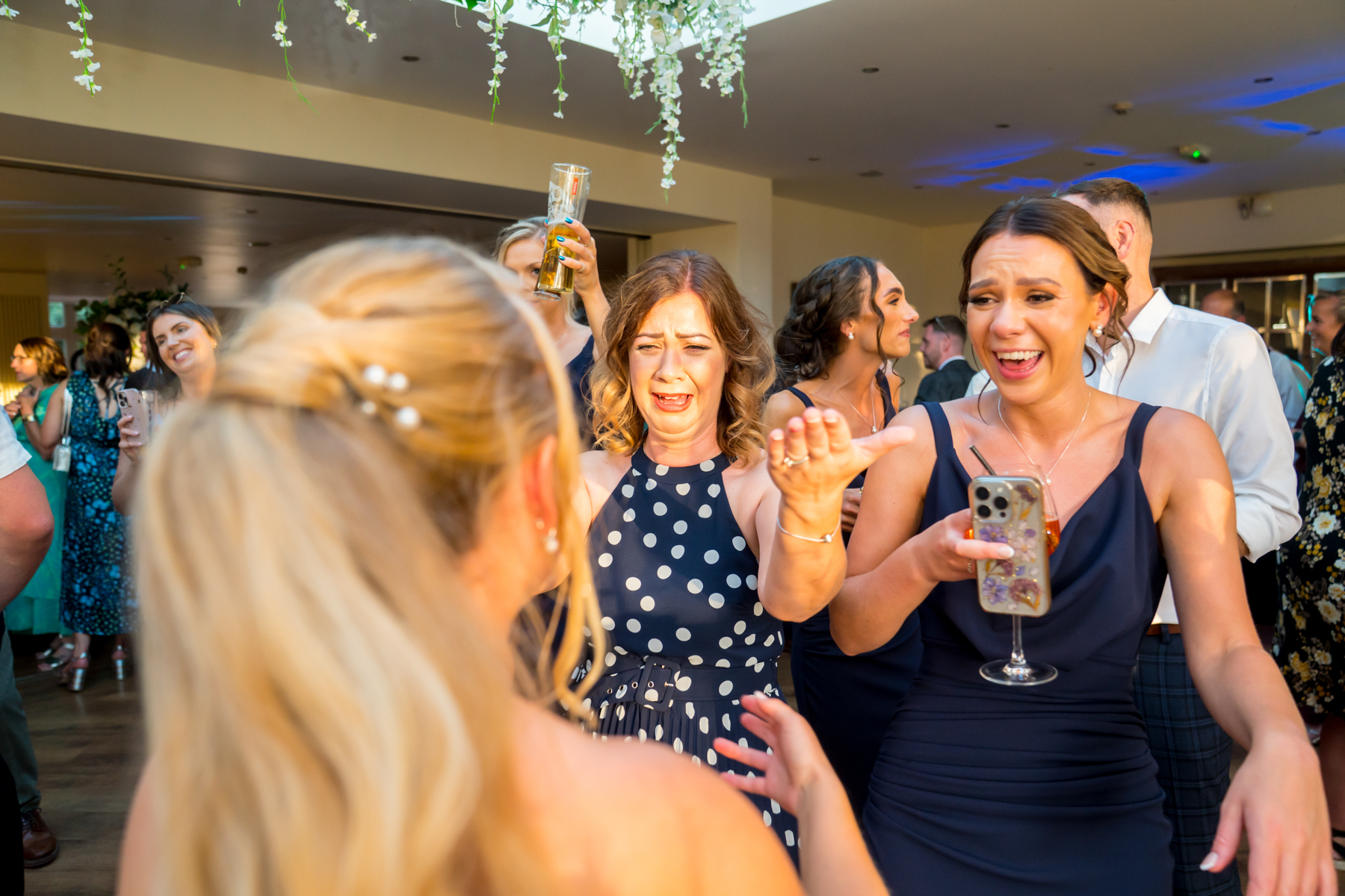 People dancing and laughing at a lively party.