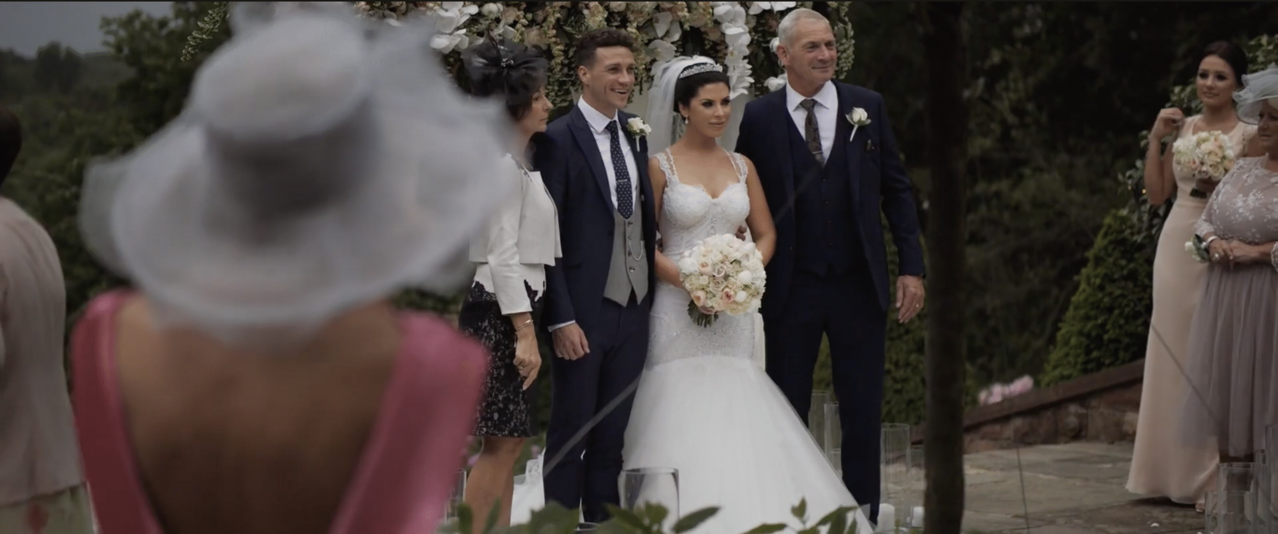 Wedding portrait with bride, groom, and guests.