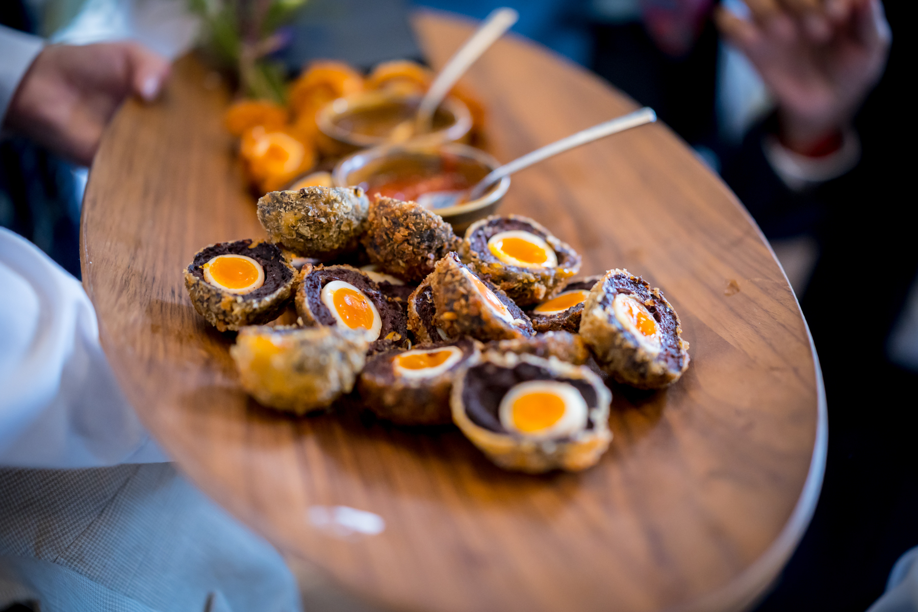 Plate of Scotch eggs with dipping sauces