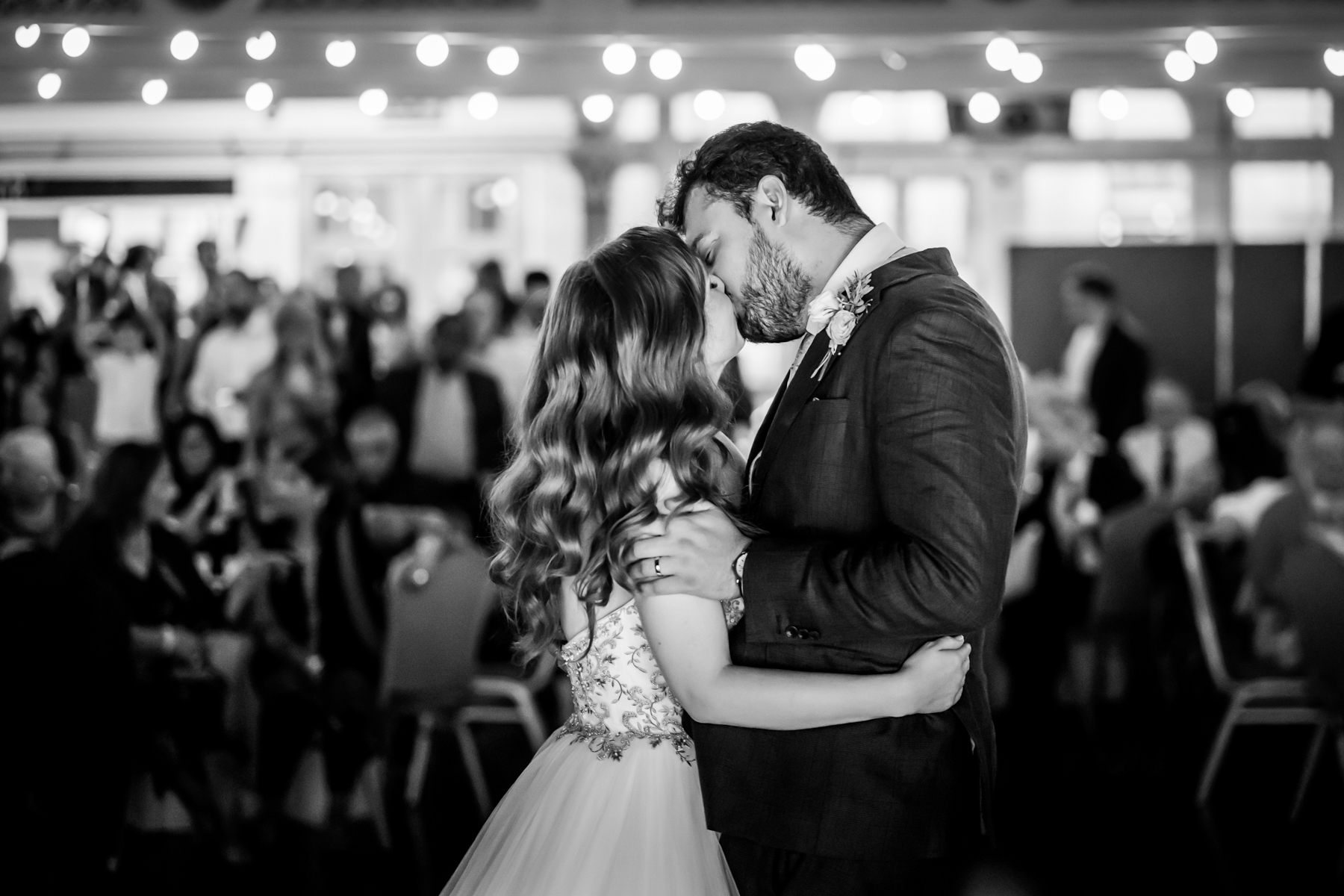 Bride and groom share wedding dance kiss