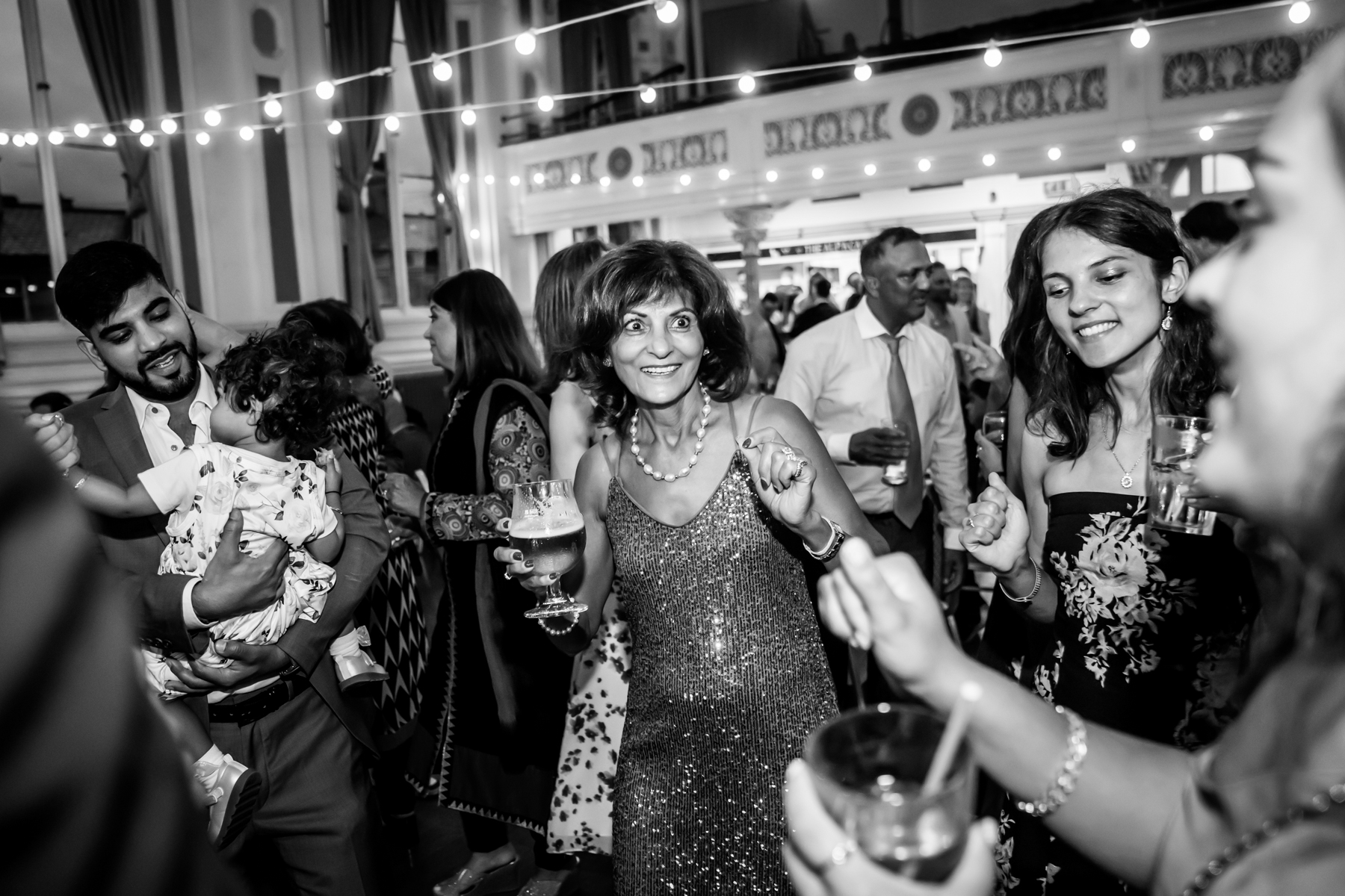 People dancing and smiling at a lively event.