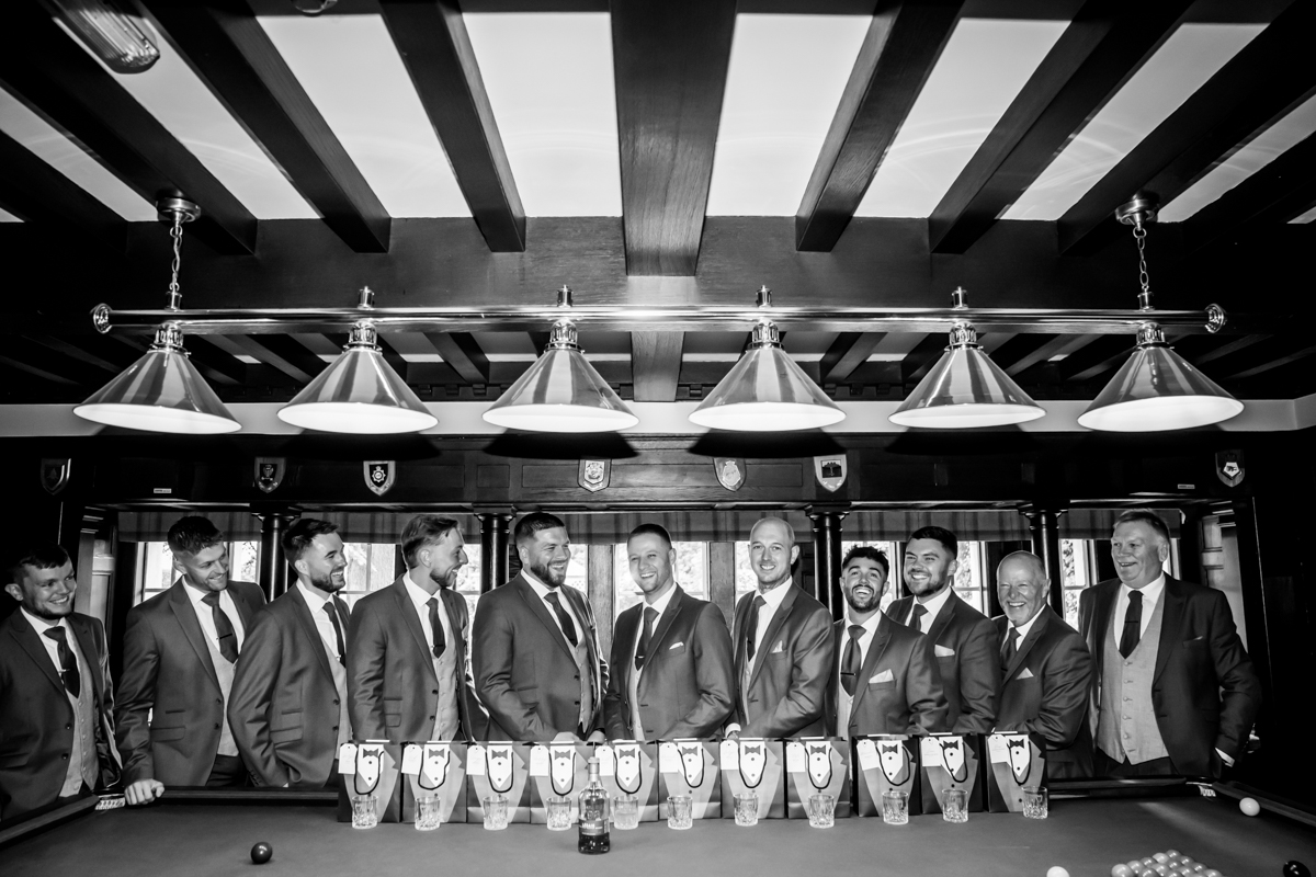 Men in formal attire at a pool table party.