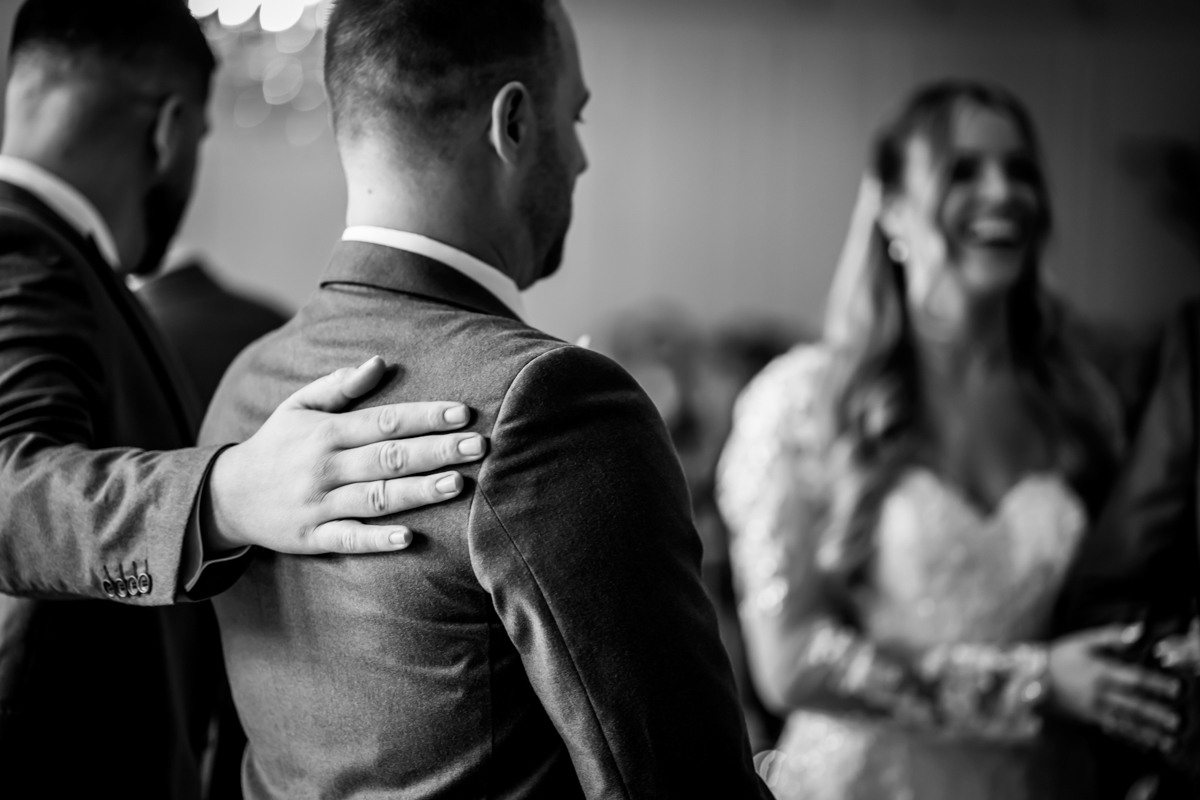 Groom receiving support before wedding ceremony