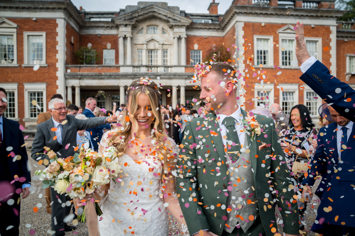 Bride and groom surrounded by wedding confetti.