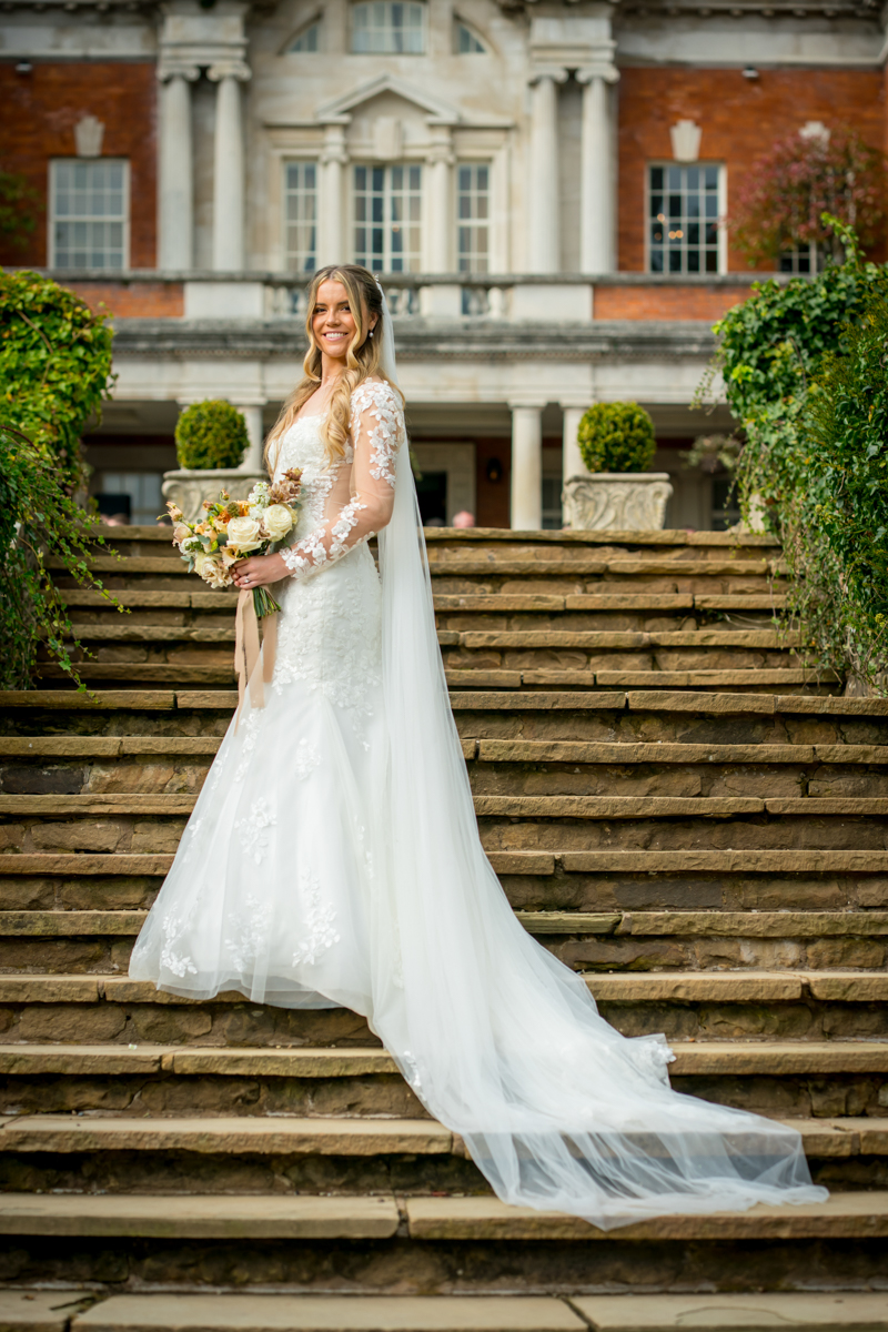 Bride in wedding dress on stone steps