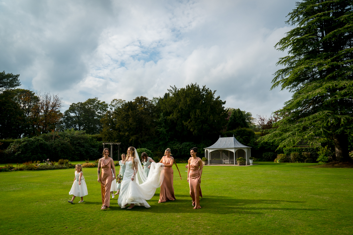 Bride and bridesmaids walking in garden