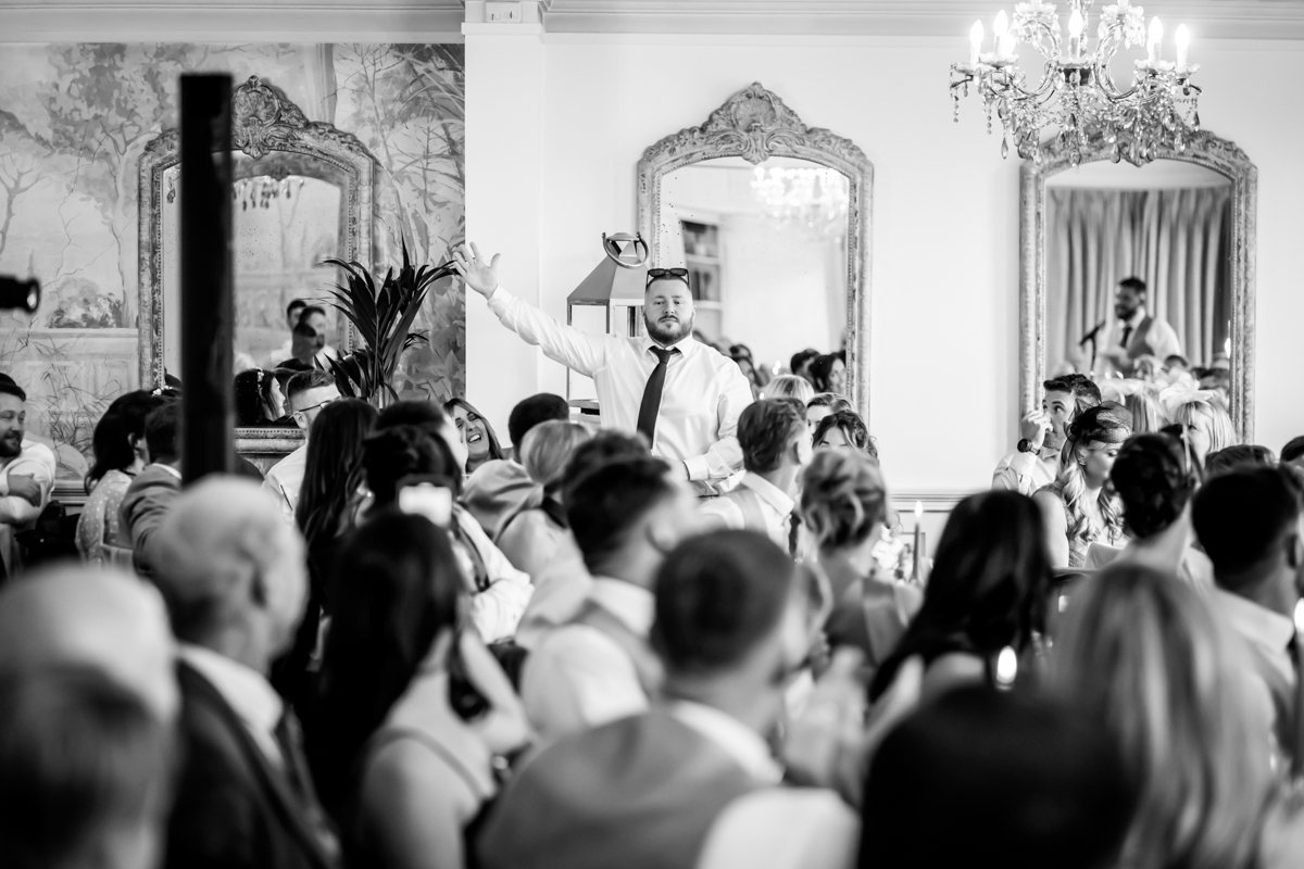 Man giving speech at formal event gathering.