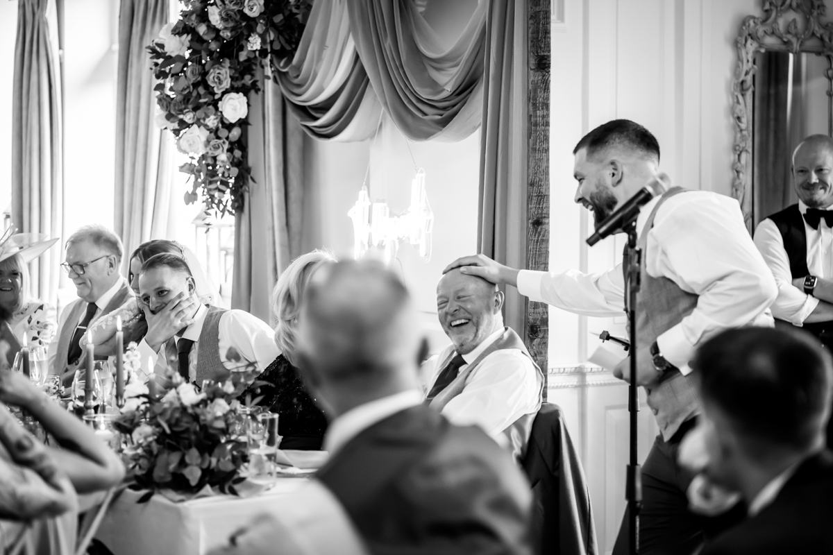Wedding speech interaction with laughing guests.