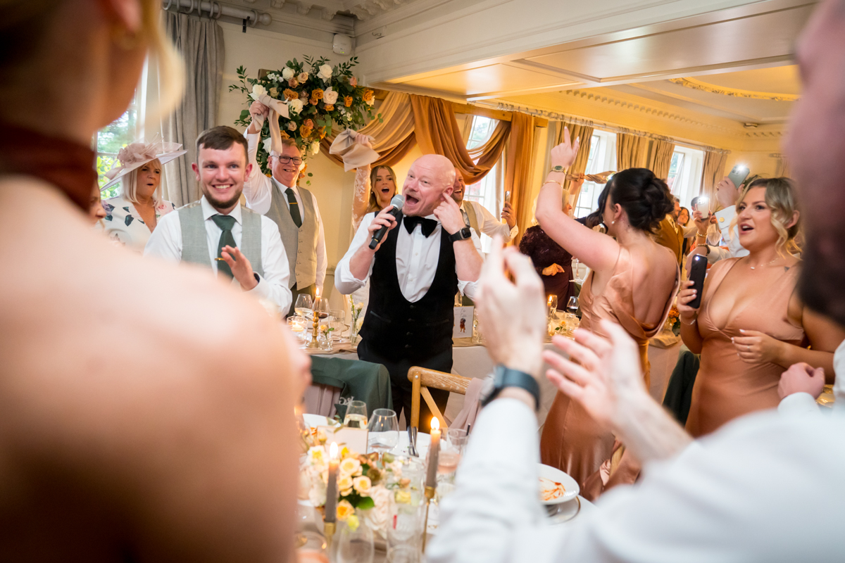 Guests celebrating at a joyful wedding reception.
