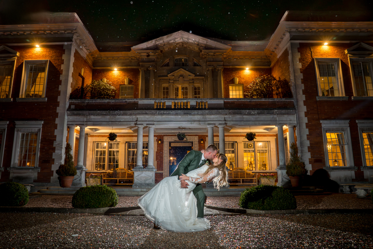 Couple dancing at night outside grand building