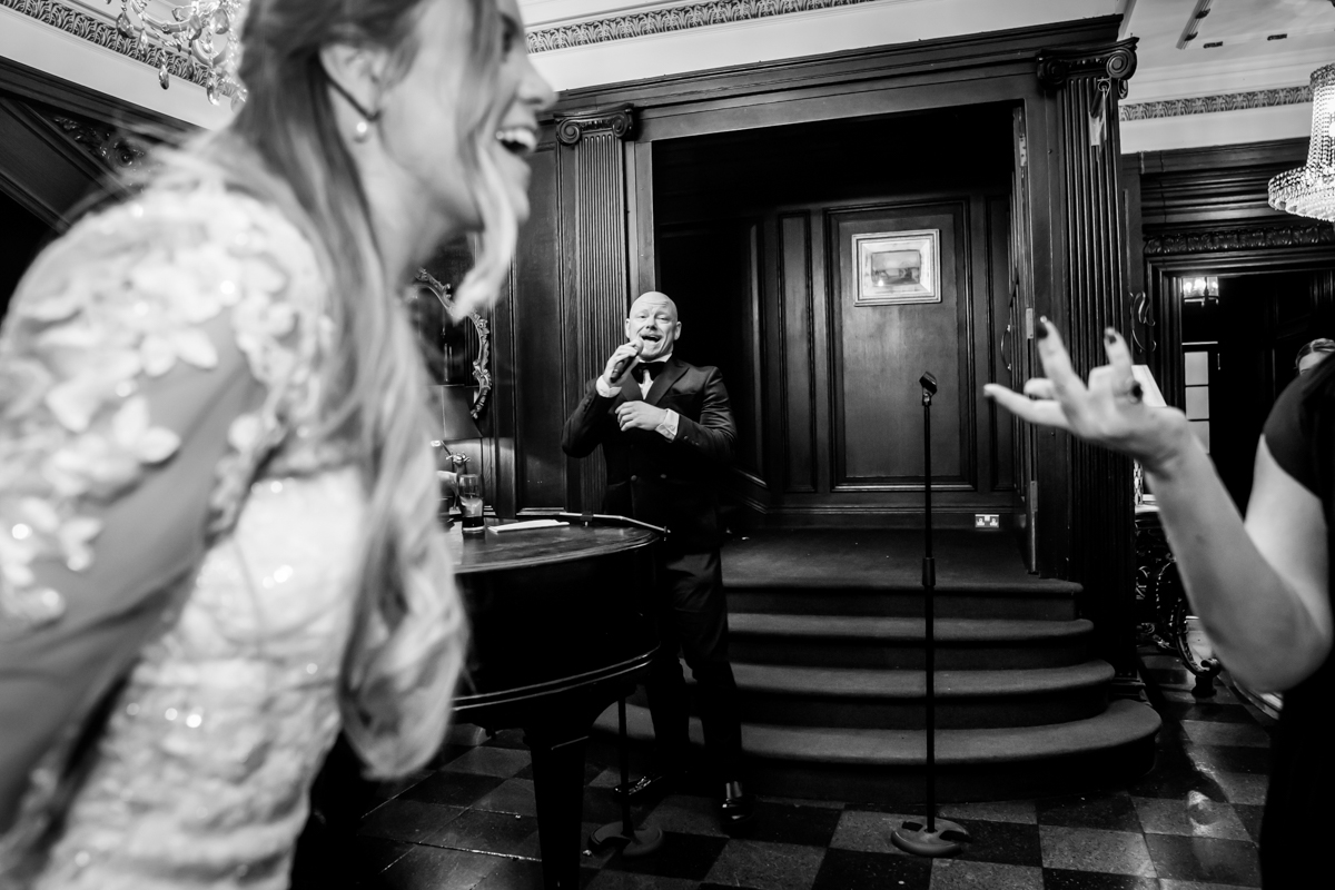 Singer performing at elegant event with audience interaction.