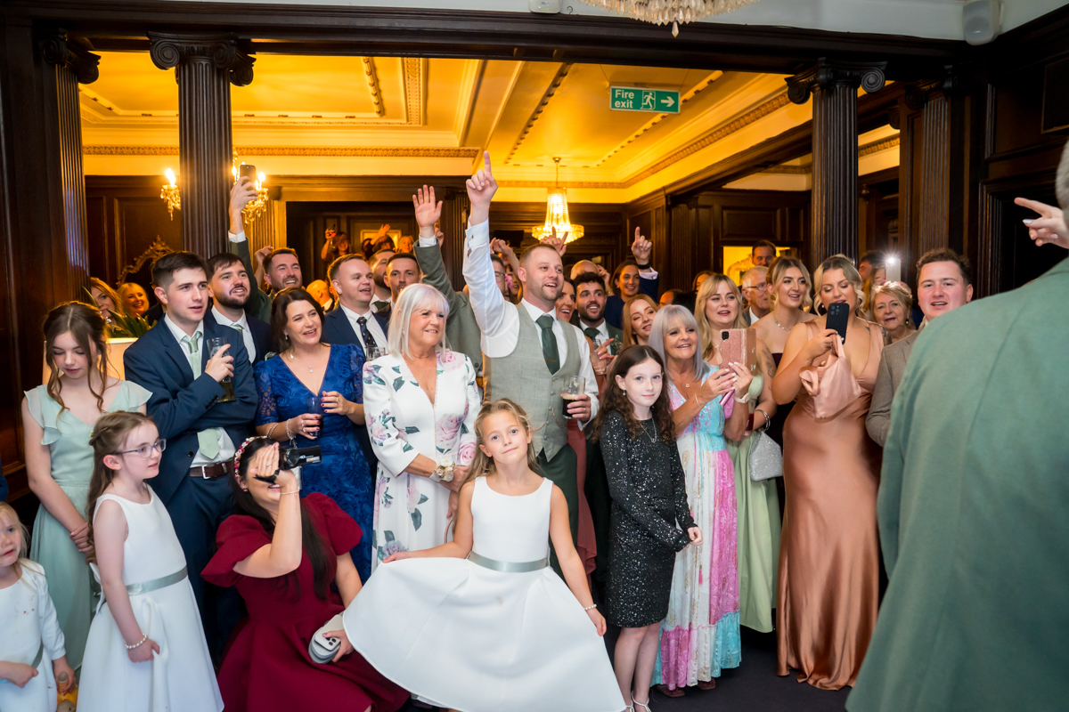 Group of people celebrating at an indoor event.