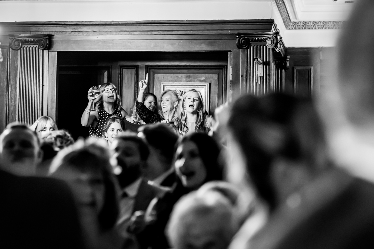 Group celebrating at indoor event with cheers