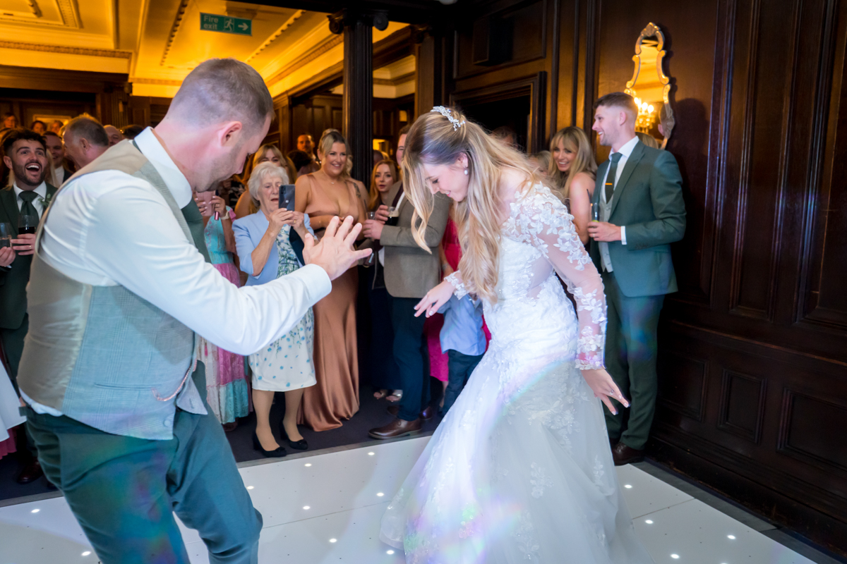 Bride and groom dancing at wedding reception.