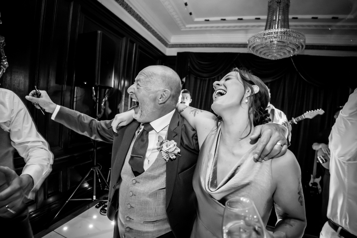 Guests laughing and dancing at wedding reception