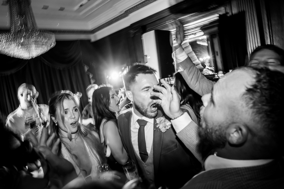 Guests dancing energetically at a lively party.