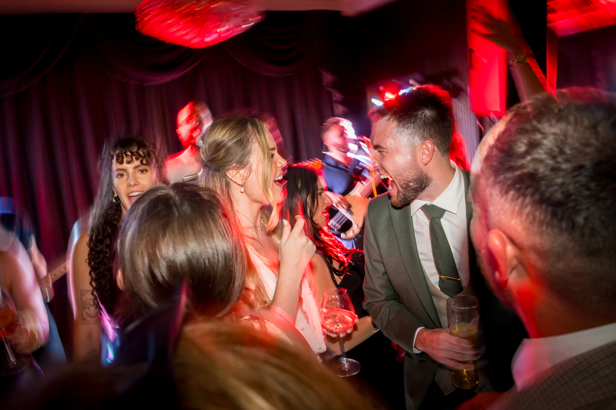 People celebrating energetically at a lively party.