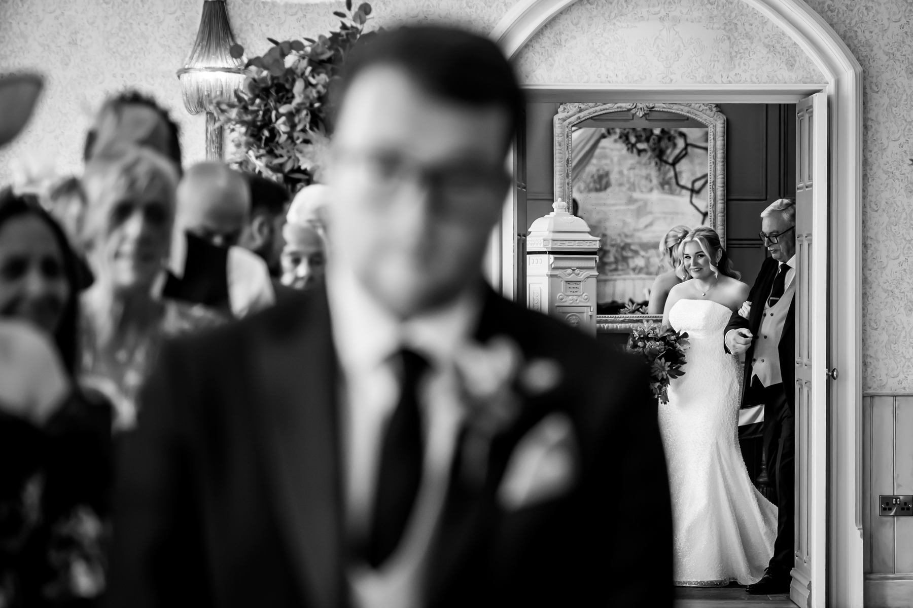 Bride entering ceremony with father at wedding.
