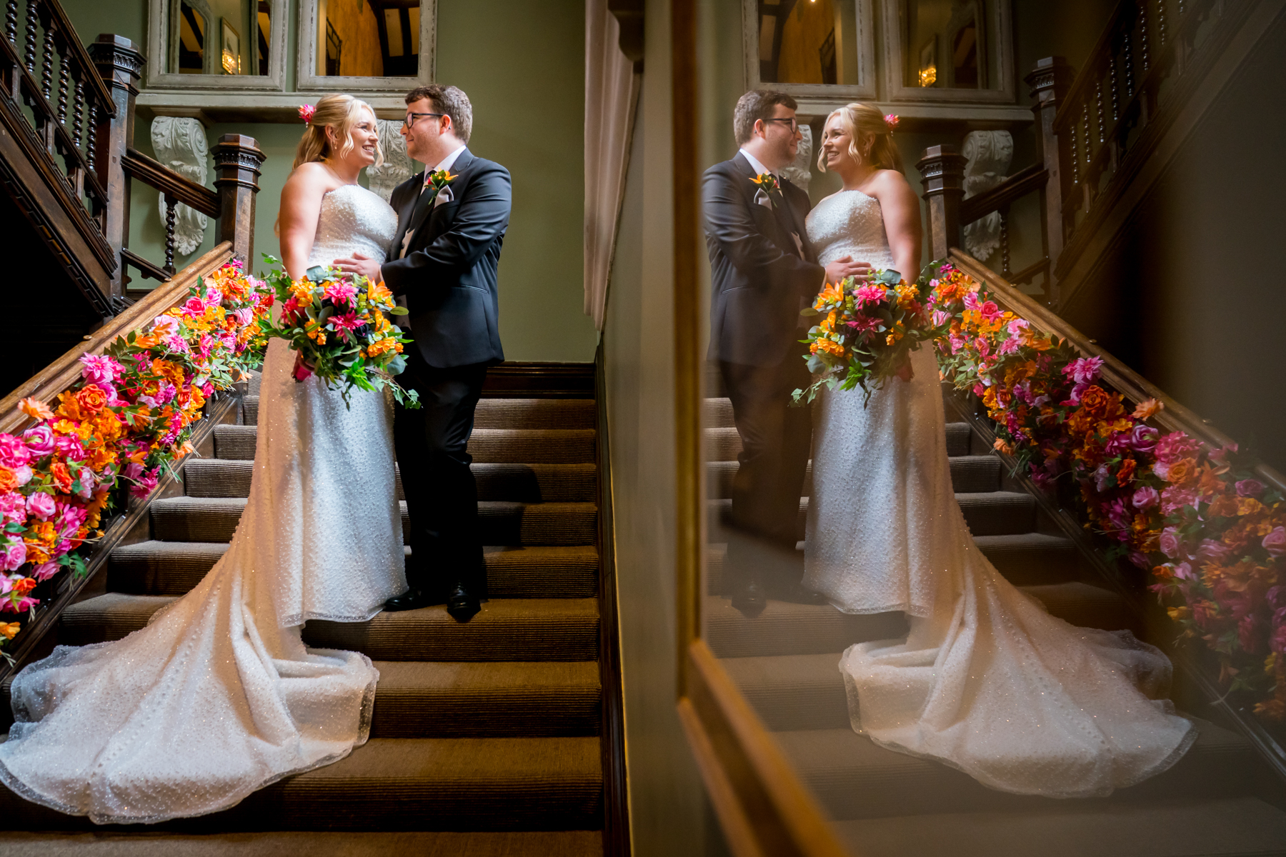 Bride and groom on floral-decorated stairs, smiling together.