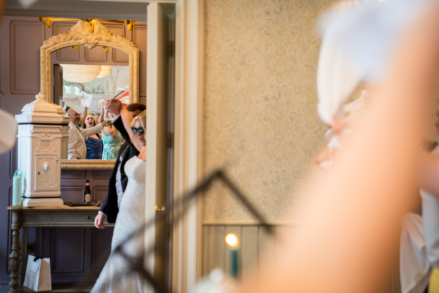 Bride reflected in mirror at wedding celebration.