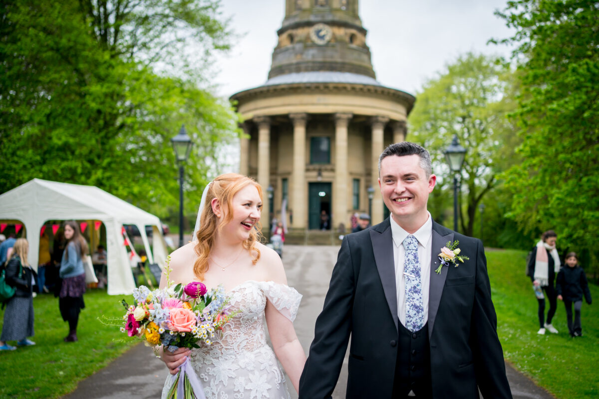 Bride and groom walking happily outdoors