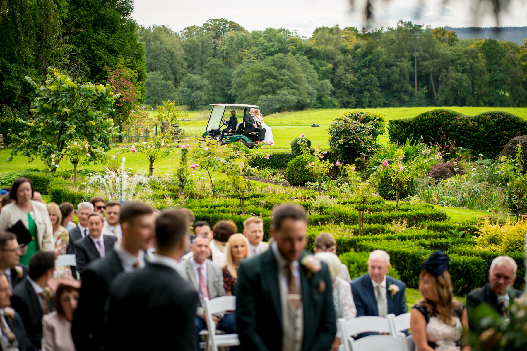 Golf cart arriving at outdoor wedding ceremony