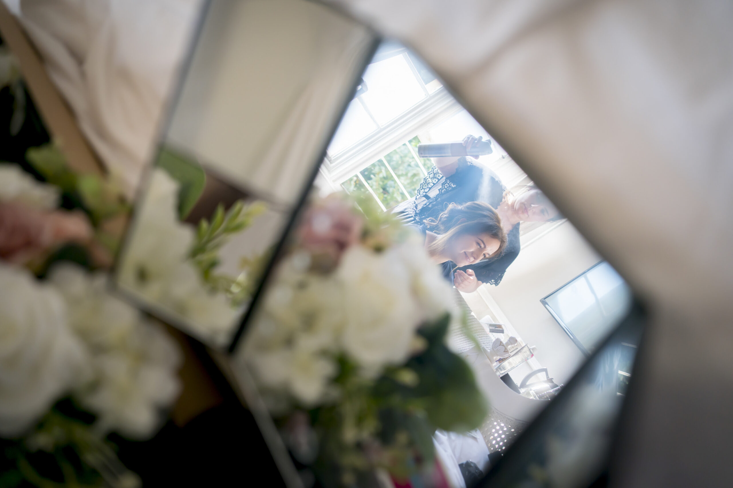 Reflection of woman getting hair styled