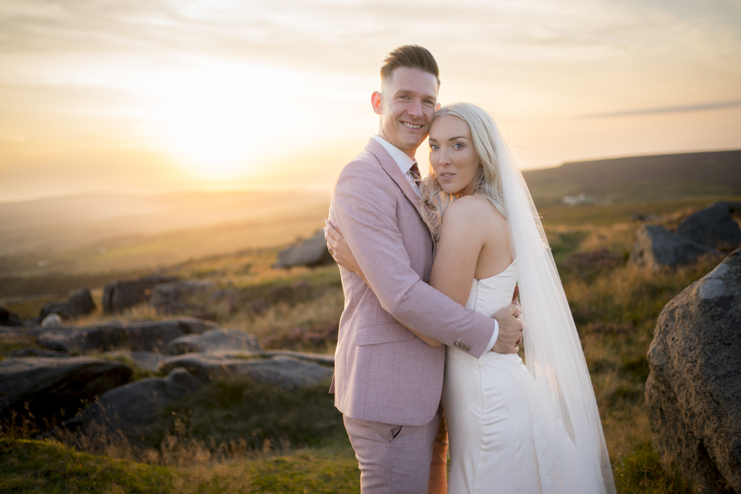 Bride and groom at sunset landscape