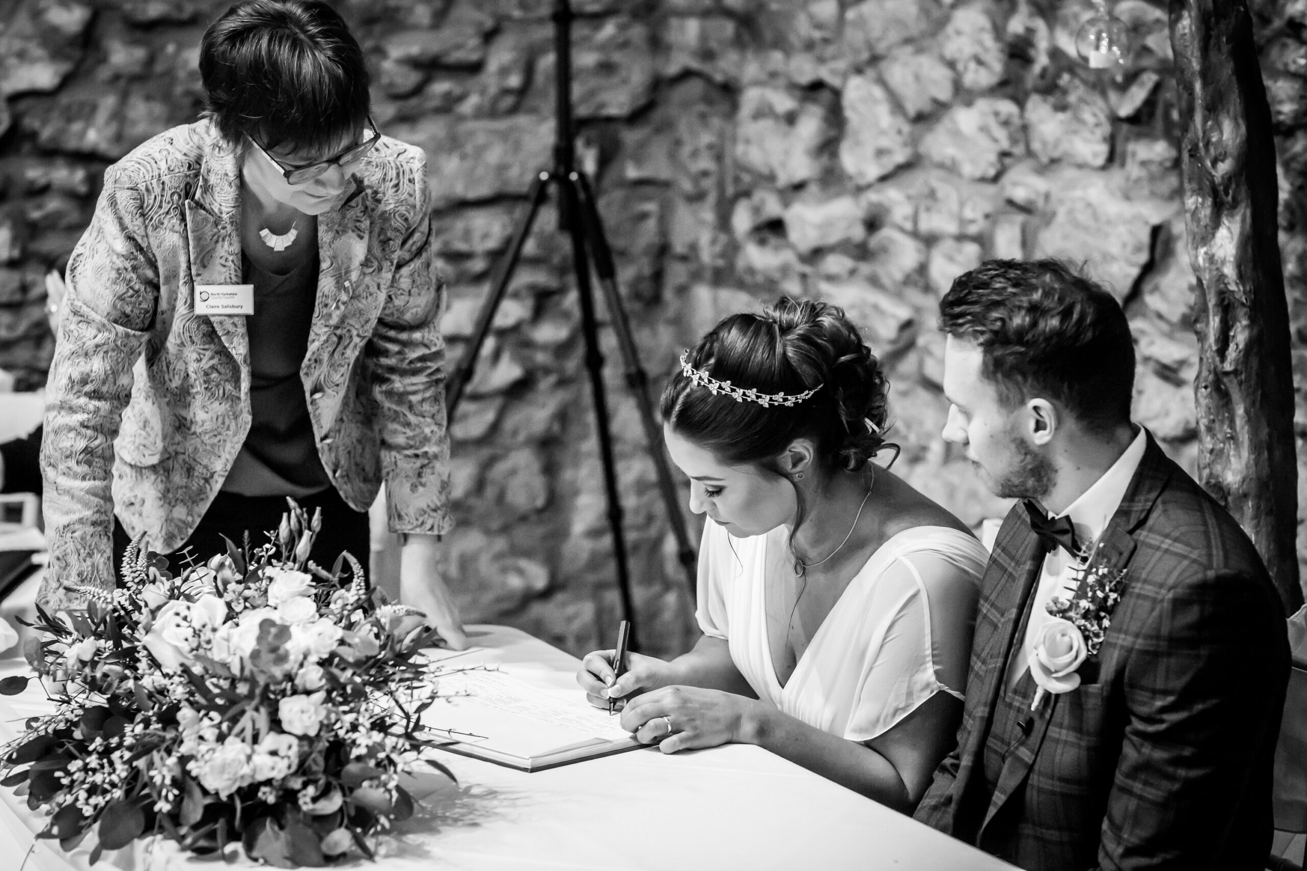 Bride signing marriage certificate