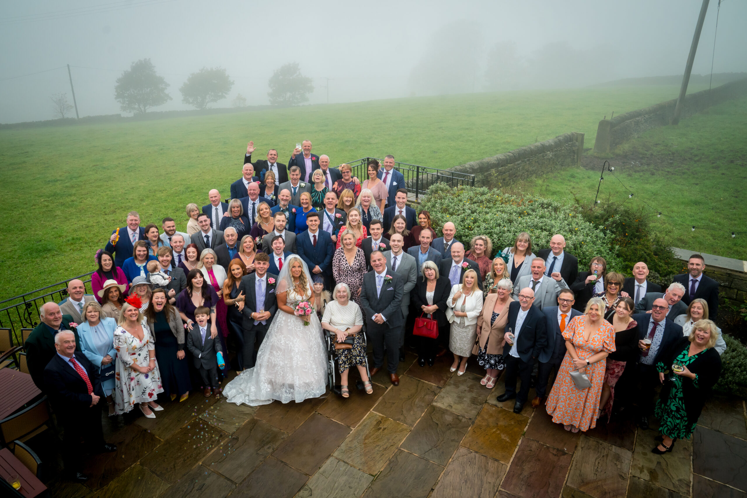 Large wedding group in outdoor setting