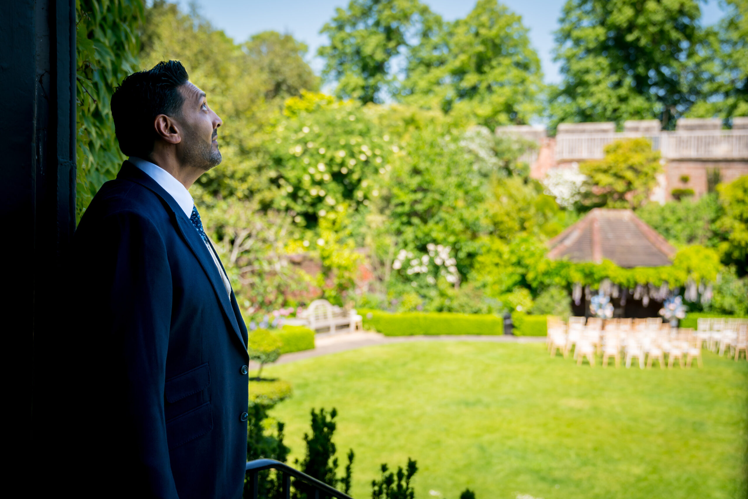 Man in a suit gazing at garden view