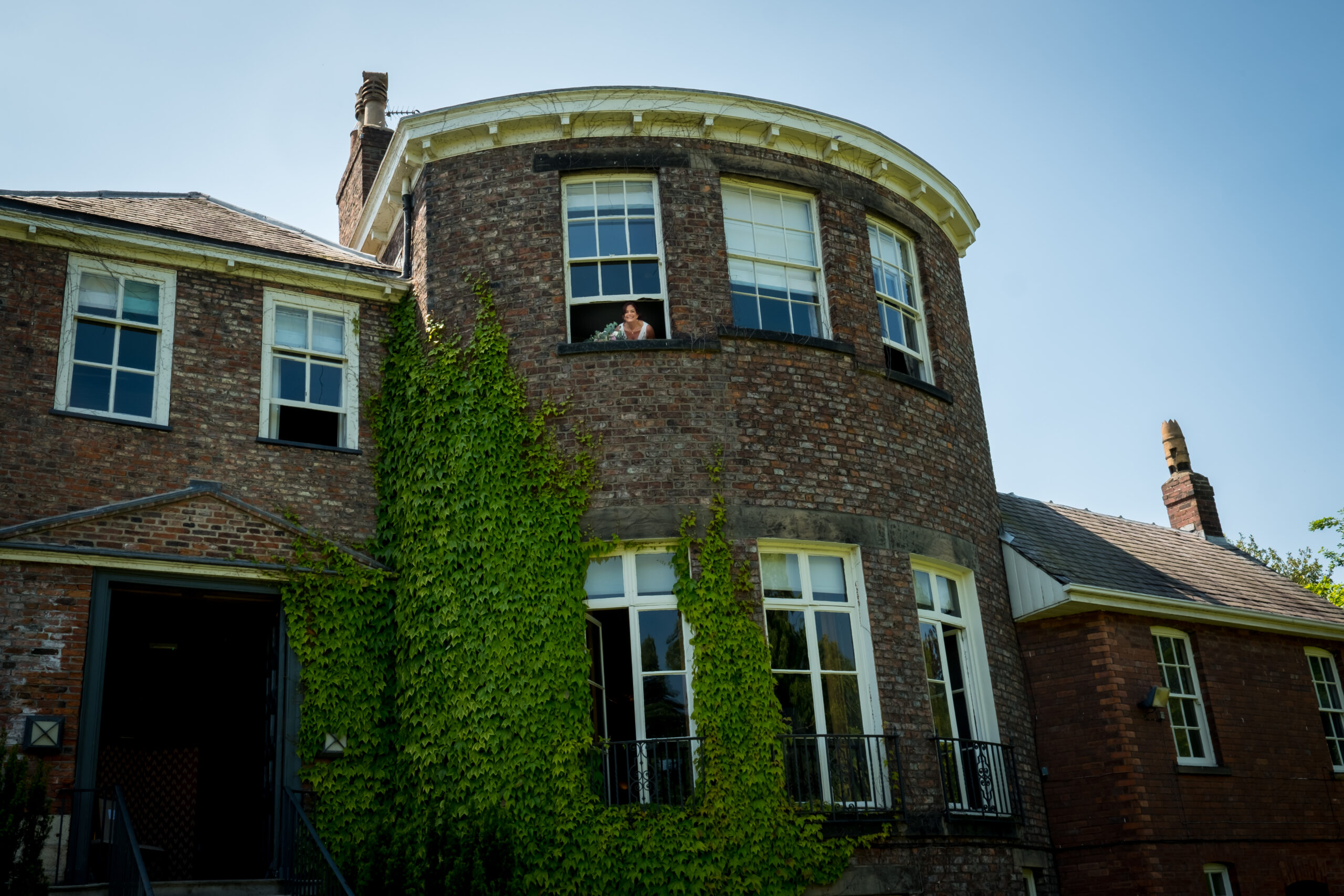 Old brick building with ivy-covered walls
