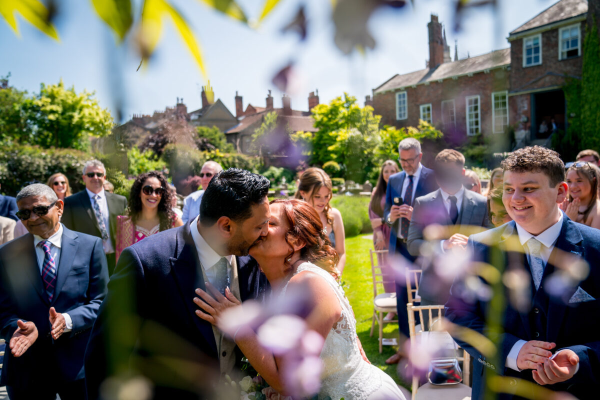 Bride and groom kissing at outdoor wedding