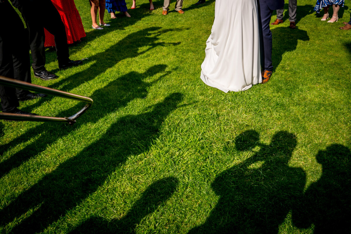 Wedding couple with cast shadows on grass
