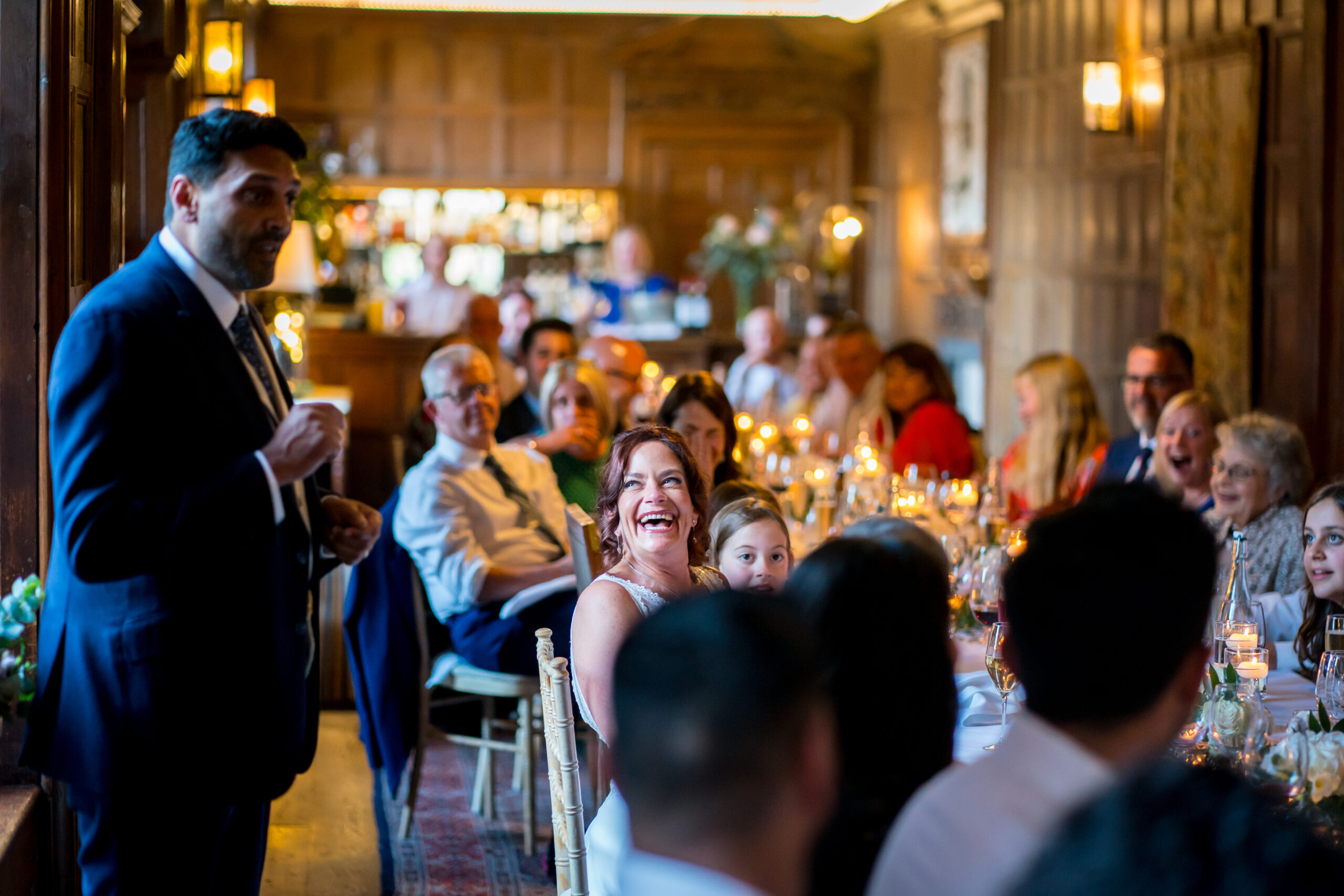 Man giving speech at joyful wedding reception