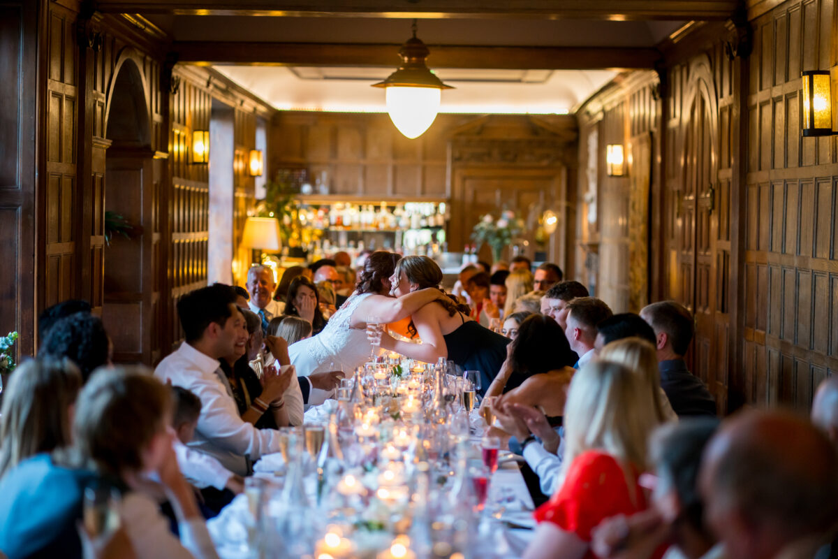 Wedding guests in elegant wood-panelled hall
