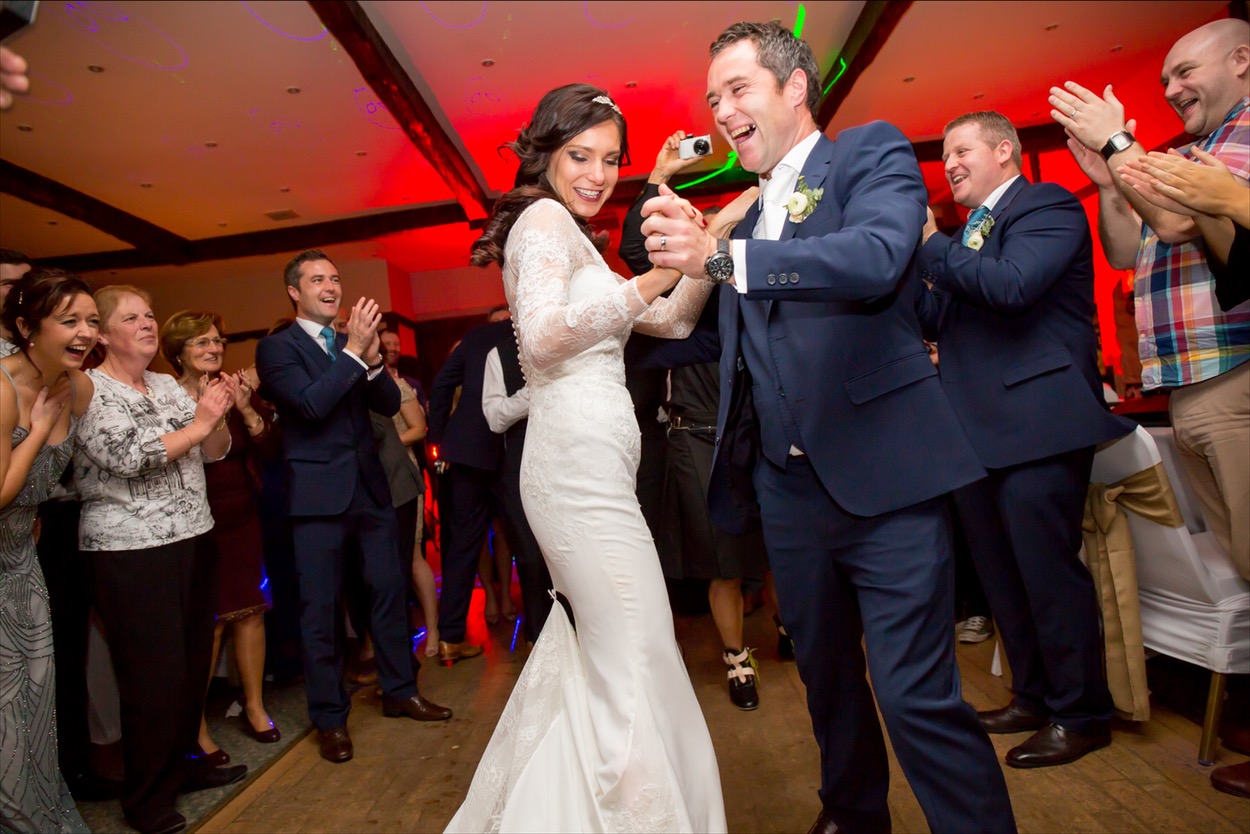 Bride and groom dancing joyfully at wedding