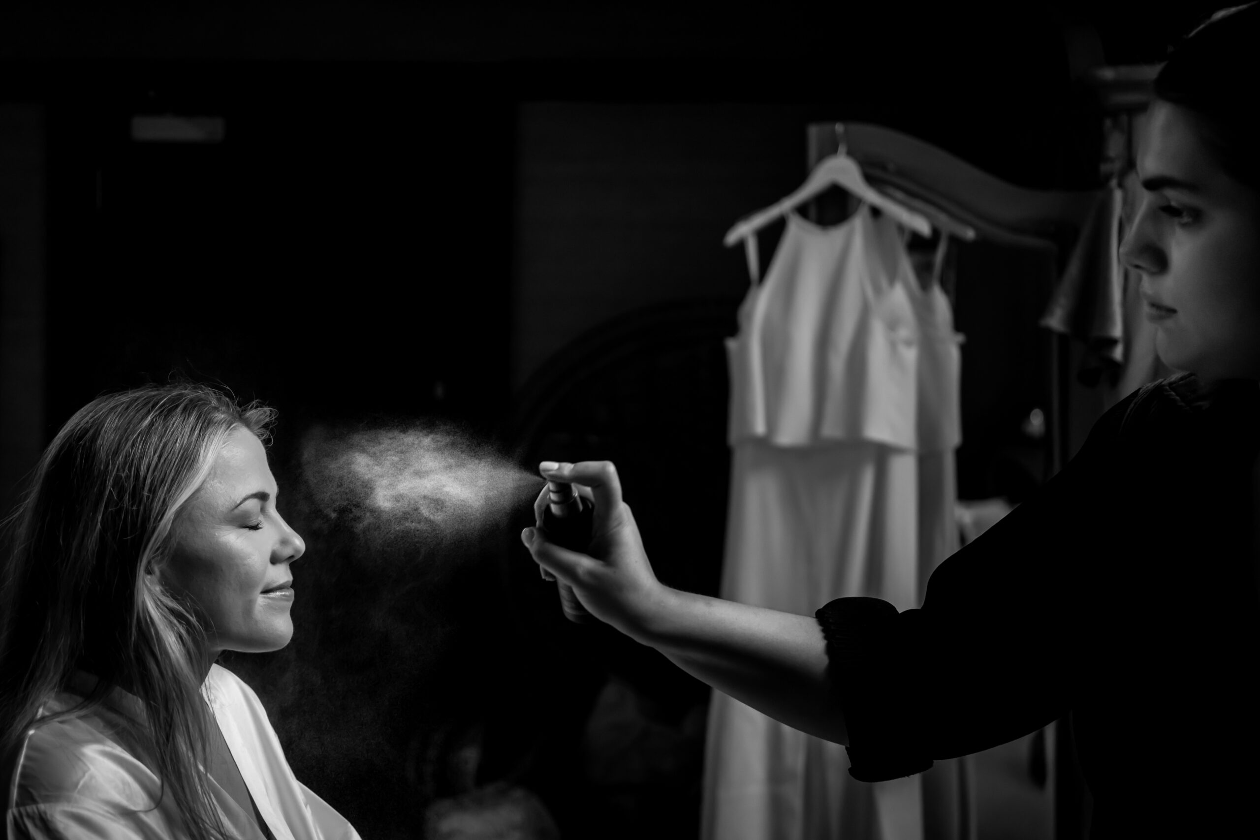 Woman gets her makeup set with spray