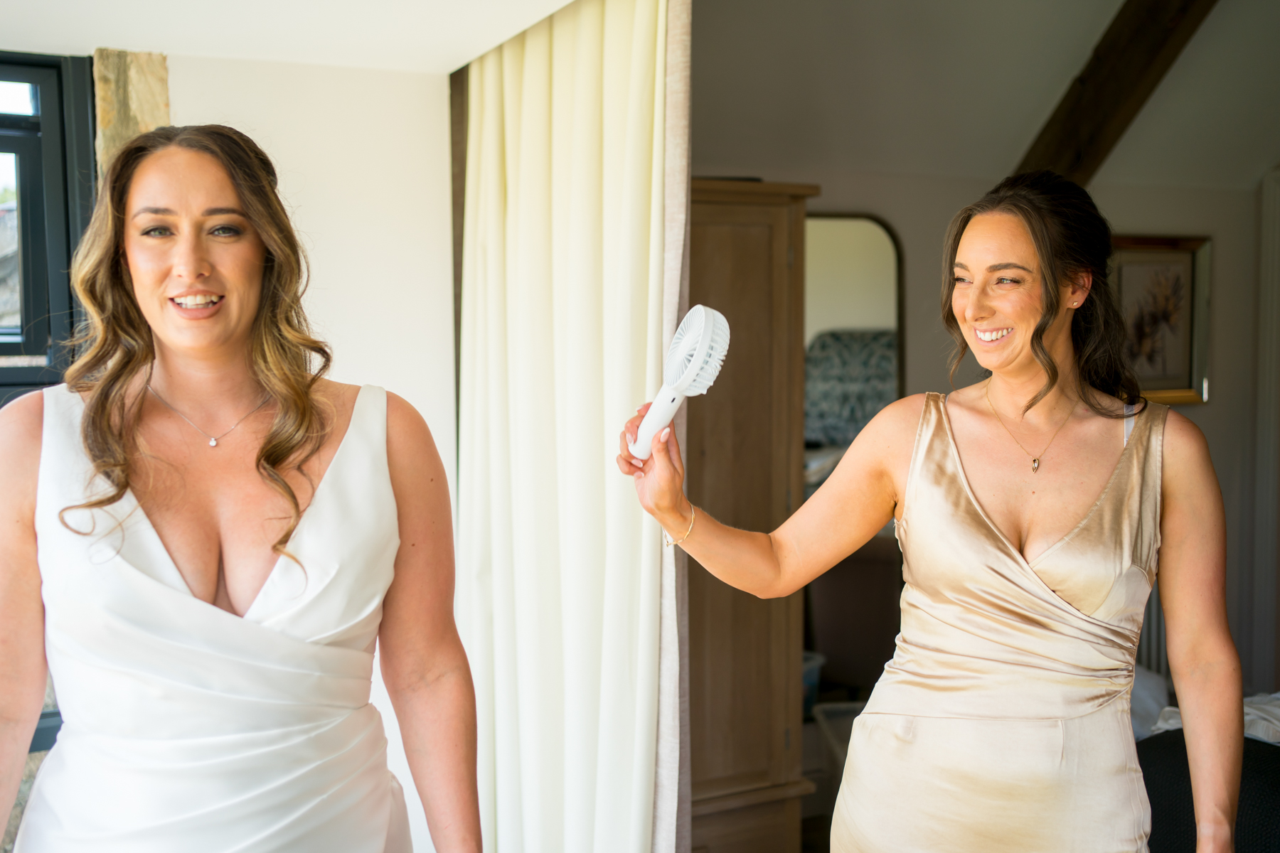 Woman fanned while getting ready indoors