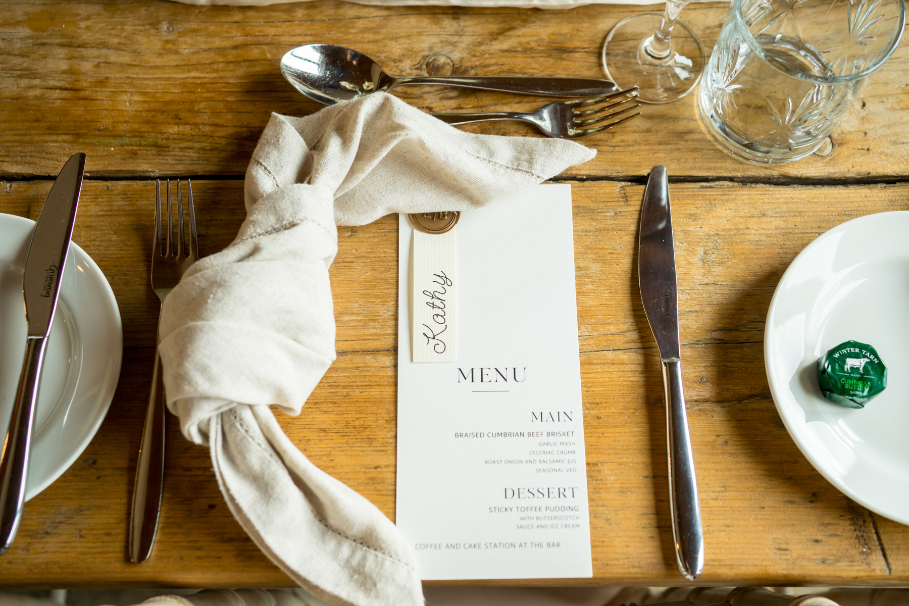Rustic wedding place setting with menu and napkin