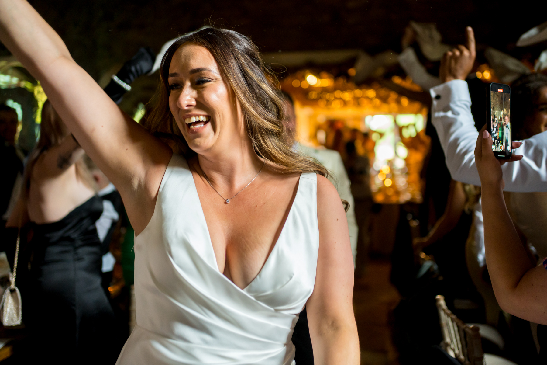 Woman dancing joyfully at wedding reception party
