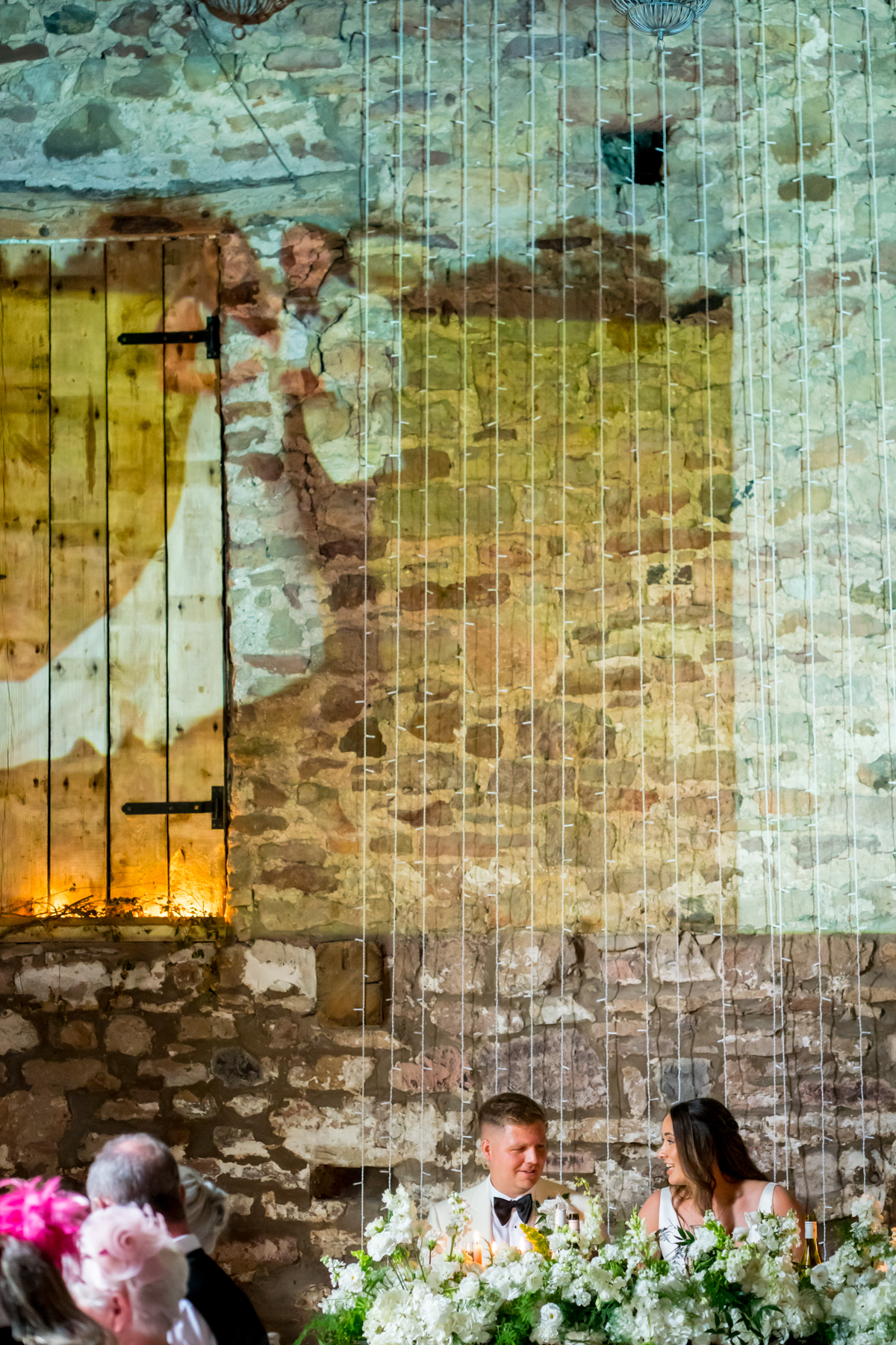Bride and groom at rustic wedding reception table