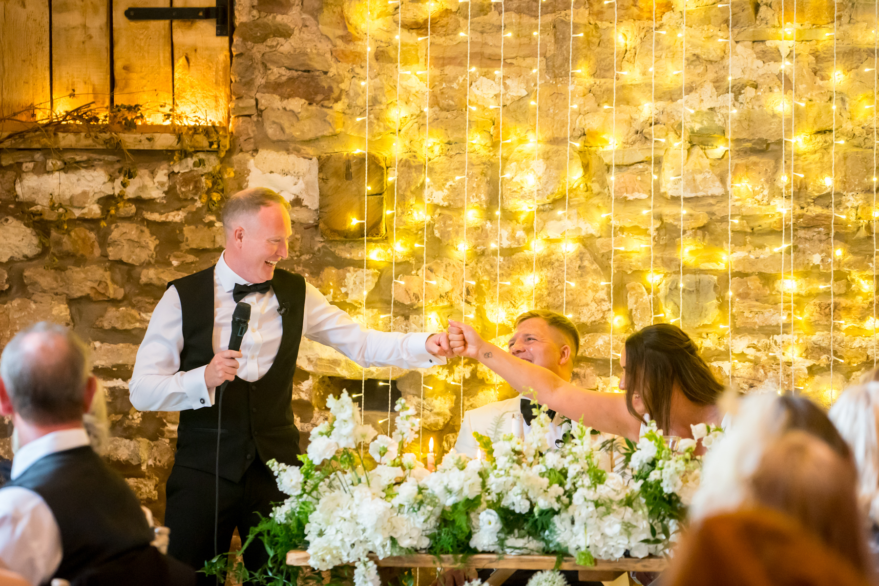 Wedding speech with groom and bride fist bumping