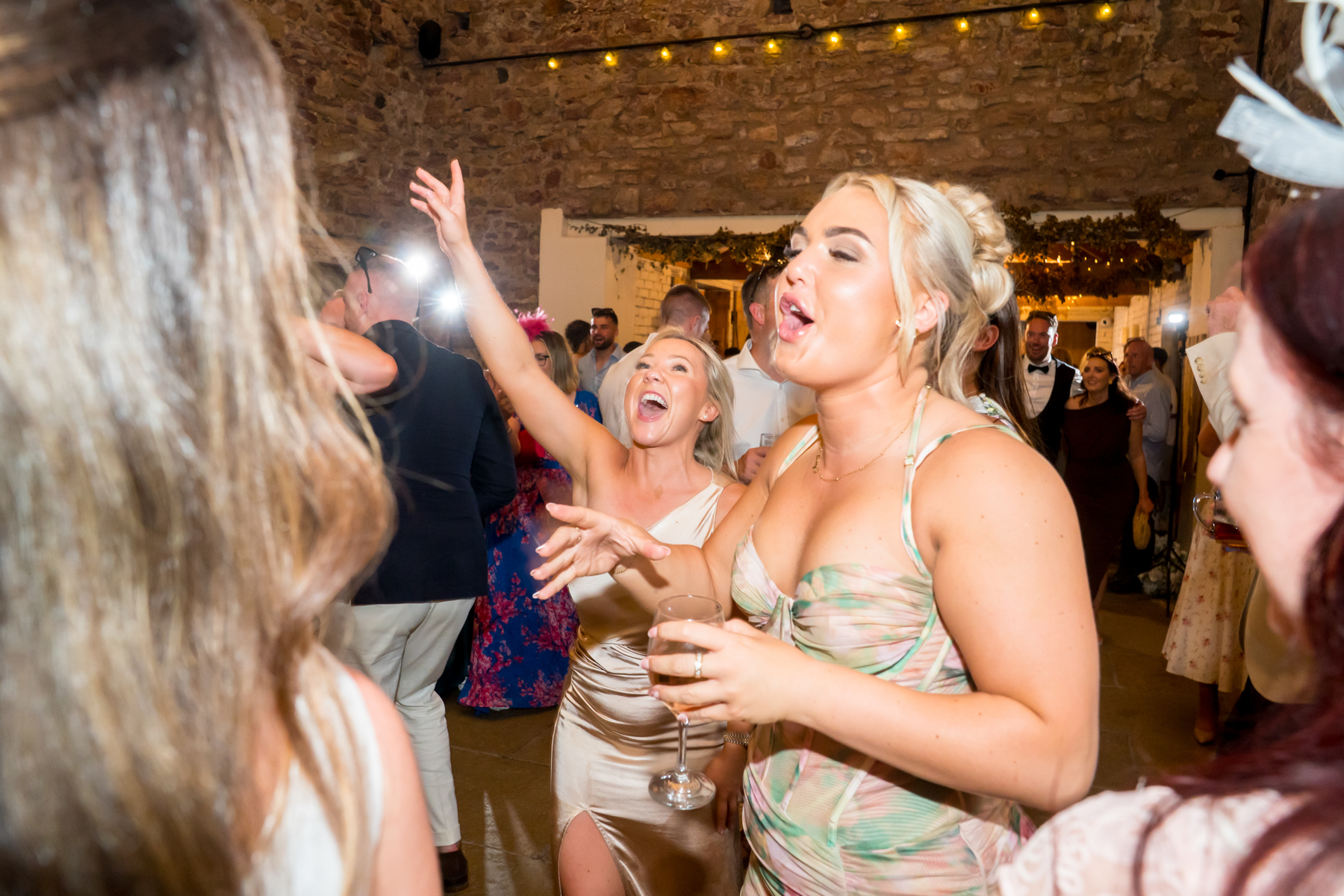 Guests dancing at rustic wedding reception
