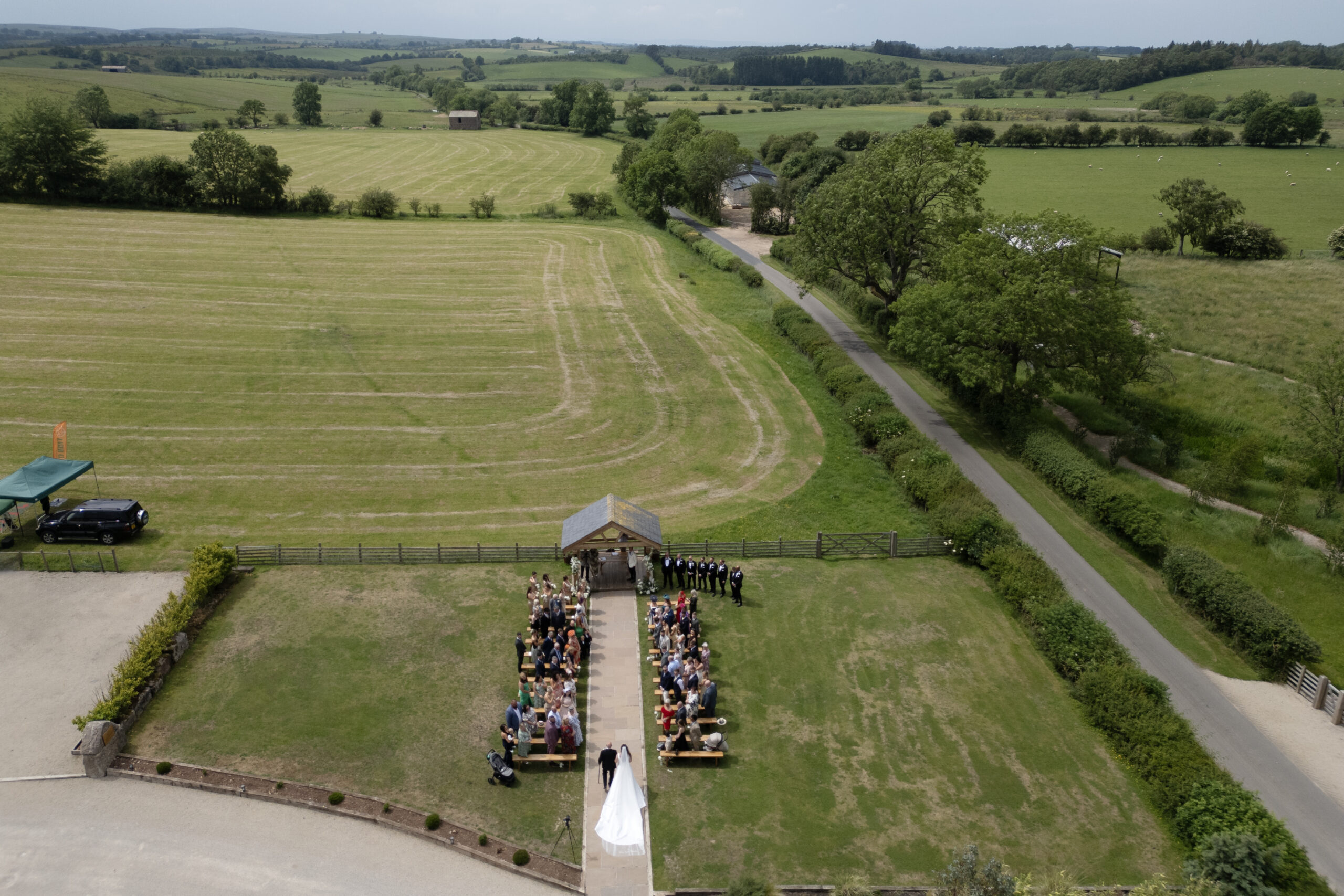 Aerial view of countryside outdoor wedding ceremony