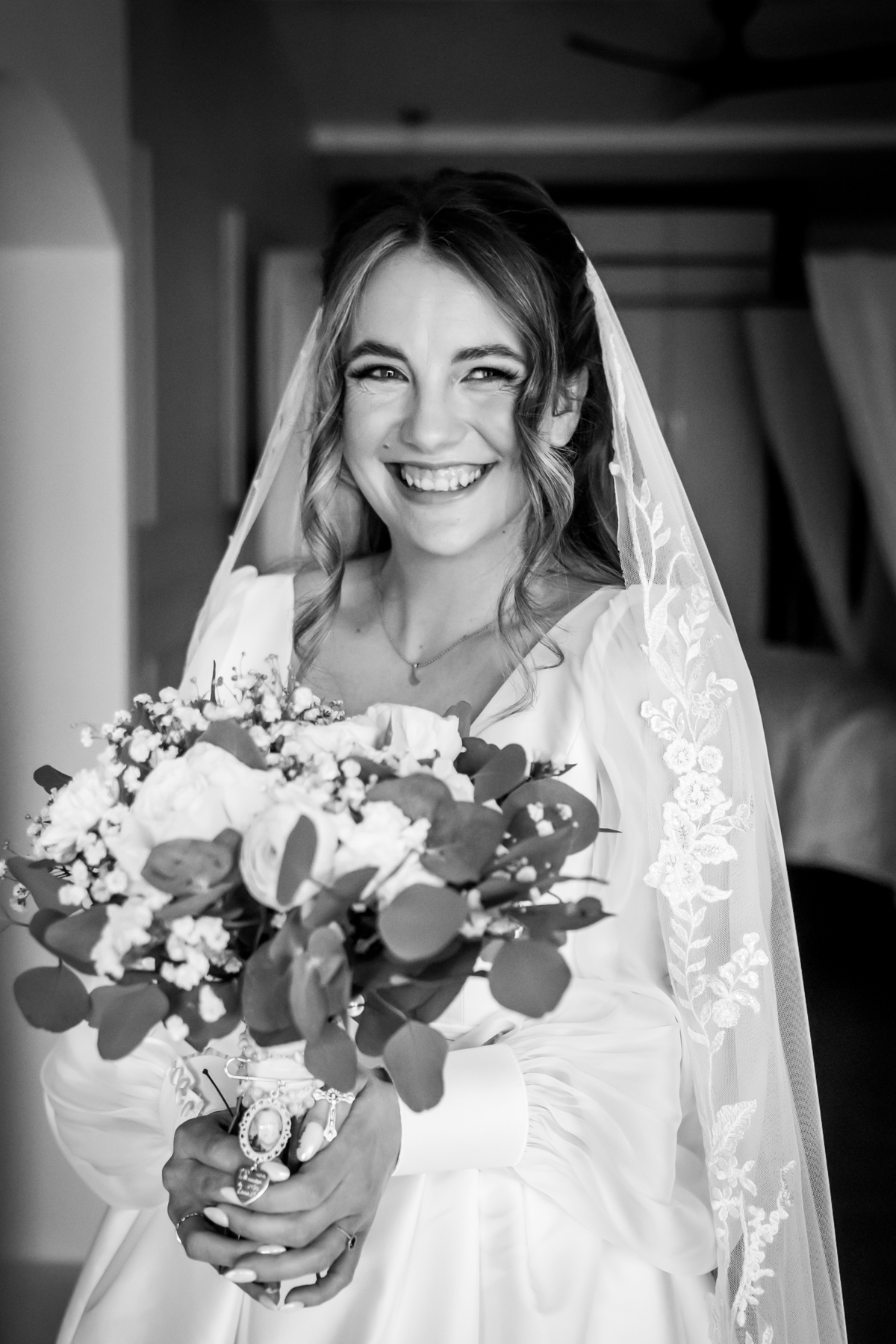 Smiling bride holding bouquet on wedding day
