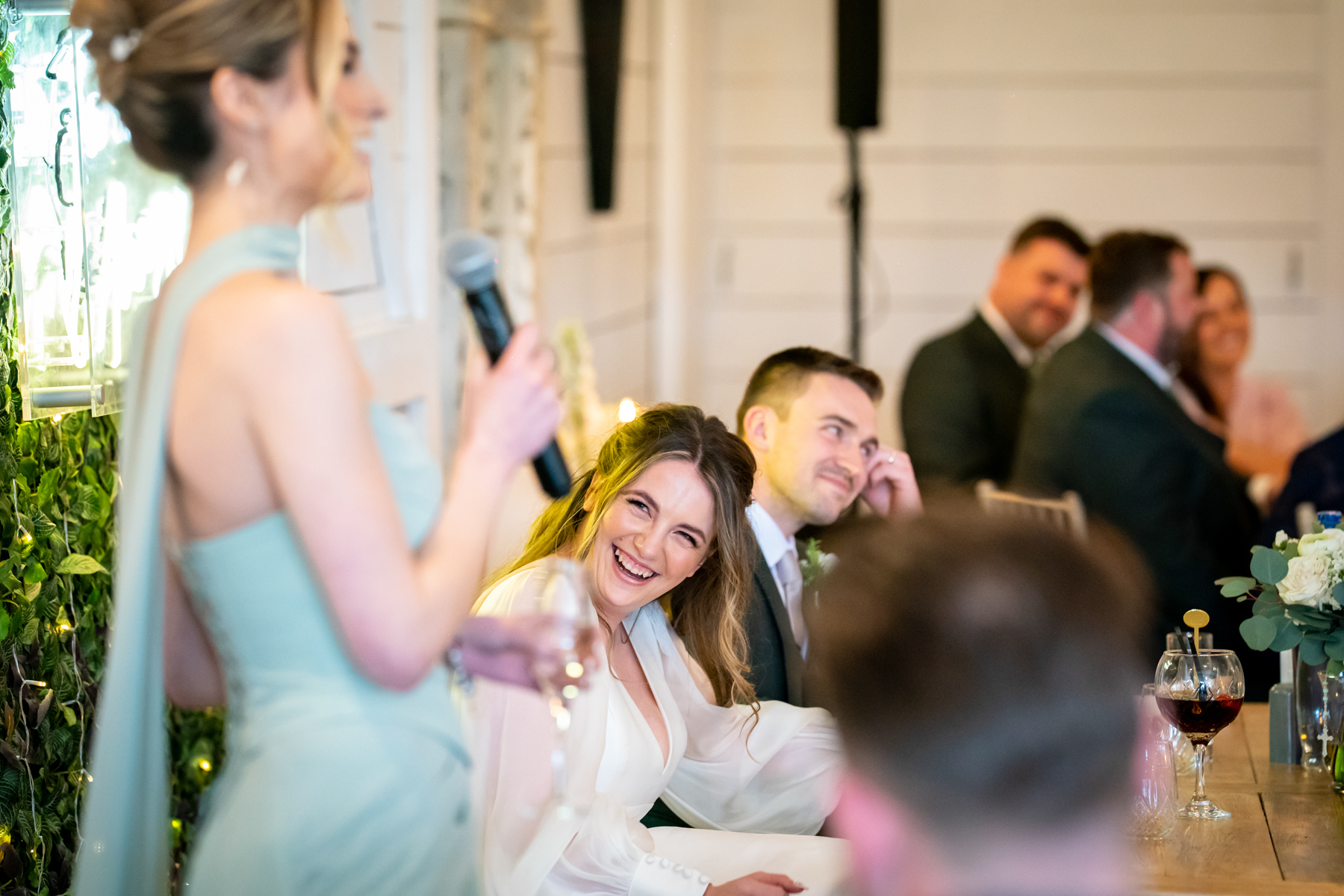 Bridesmaid giving speech at wedding reception