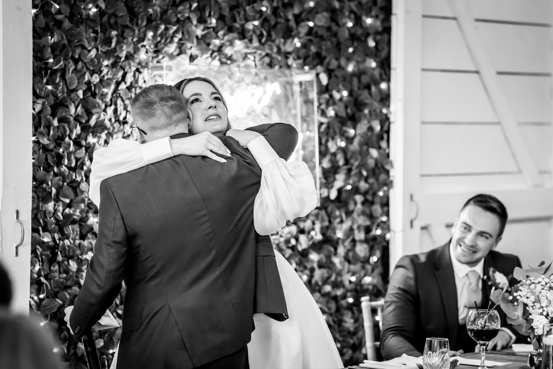 Bride hugging father at wedding reception