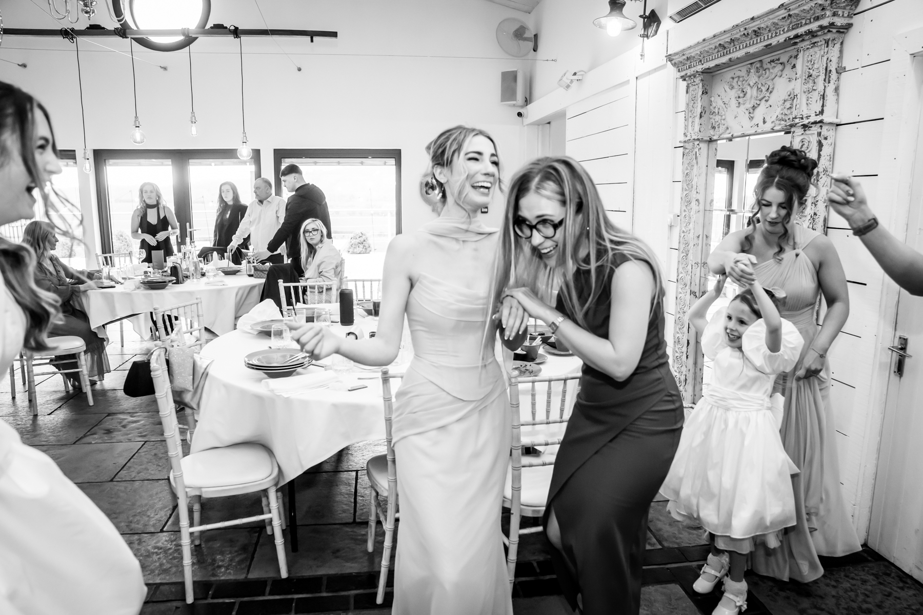 Bride laughing with guests at wedding reception